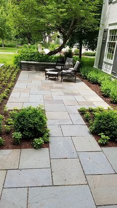 an outdoor patio with stone walkway and seating area