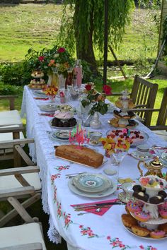 a long table covered with plates and cakes