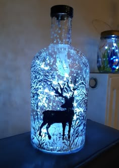 a lighted glass bottle with a deer on it