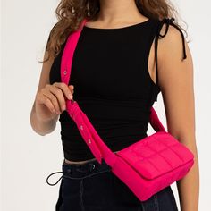 Puffer Crossbody Bag In Magenta. Nylon Puffer Bag. Magnetic Button Closure. Interior Organizational Pocket. Adjustable Shoulder Strap With Gold Toned Eyelets. 8.5''W X 4.5''H X 2.25''D. Shell: 100% Nylon. Lining: 100% Polyester. Imported. Trendy Nylon Mobile Phone Bag, Chic Pink Nylon Bag, Spring Nylon Crossbody Shoulder Bag, Spring Nylon Bags With Adjustable Strap, Spring Nylon Bag With Adjustable Strap, Pink Nylon Mobile Phone Bag, Trendy Nylon Shoulder Bag, Pink Nylon Bag With Detachable Strap, Pink Nylon Shoulder Bag With Detachable Strap