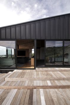 a wooden deck with sliding glass doors on it