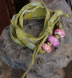 Unique Bracelet/Necklace made with High Quality Lampwork Beads, a beautiful Rhodochrosite Bead and a Ribbon made of Original Indian Sari Silk It can be used either as a Bracelet or a Necklece to be knotted Beads and Ribbon can be used separately at your convenience Sari Silk Bracelet, Silk Wrap Bracelets, Sari Ribbon, Silk Bracelet, Ribbon Necklace, Wrap Bracelets, How To Make Ribbon, Indian Sari, Sari Silk