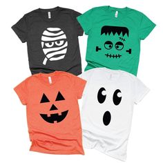 three halloween t - shirts with faces on them, one is green and the other is orange