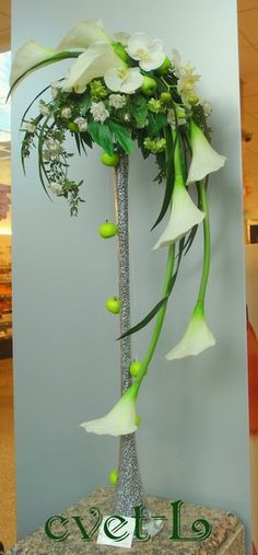 there is a vase with flowers in it on top of a table at an office