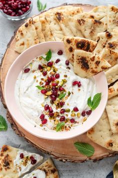 pita bread with yogurt and pomegranate garnished with mint