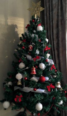 a decorated christmas tree with red and white ornaments