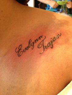 the back of a woman's shoulder with an inscription on it