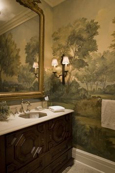 a bathroom with a painting on the wall and two sinks in front of a mirror