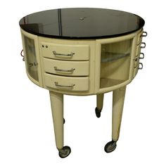 a round table with drawers and wheels on it