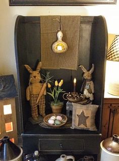 an old fashioned cabinet is decorated with easter decorations