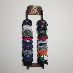 "Do you need to store or organize your caps (hunting, fishing, baseball) this double cap rack holds 20 baseball caps. It could be customized with your favorite logo and name. If you don't see the design or the logo you want please send me a message, I will be glad to work with you. Measuring 4ft high, and 1ft wide , it fits necely in your master bedroom, kids bedroom, closet, den, garage. Pictured in Kona Stain. Weight is just under 7 pounds, so it won't strain your wall. PERSONALIZE OPTION: Per Display Rack Ideas, Hat Rack Ideas, Kona Stain, Baseball Hat Racks, Baseball Cap Rack, Diy Hat Rack, Cowboy Hat Rack, Hat Shelf, Cap Rack