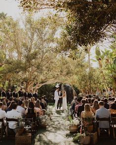 an outdoor wedding ceremony in the woods