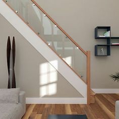 a living room with a couch, coffee table and stair case in the middle of it