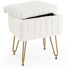 a white stool with gold legs and a black seat cushion on the bottom, in front of a white background