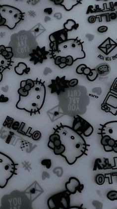 many different hello kitty stickers on a white surface with black and grey designs in the background