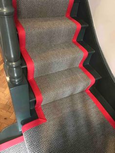 the carpeted stairs are painted red and grey