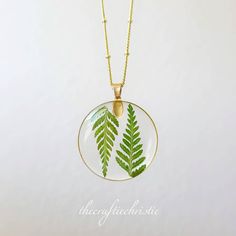 This magical necklace is crafted by systematically placing a delicate Fern in resin pendants. Choose your favorite necklace to go along with a beautiful gold chain. The Pendant and Chain are Lead free and Nickel Free! It is important to preserve the jewelry in the box provided safely after use. Enjoy this necklace with a chain length of your choice. You can see more of my Handmade Items here: https://www.etsy.com/shop/Thecraftiechristie Nature-inspired Gold Resin Jewelry, Nature-inspired Green Jewelry With Birth Flower, Gold Resin Nature-inspired Jewelry, Nature-inspired Round Necklaces For Jewelry Making, Nature-inspired Pendant Necklace With Adjustable Chain, Nature-inspired Leaf-shaped Jewelry With Pressed Flowers, Botanical Style Gold Resin Jewelry, Handmade Round Nature-inspired Necklaces, Nature-inspired Green Jewelry With Pressed Flowers