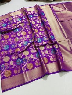 Beautiful semi georgette floral minakari jangla weaved saree with heavy golden zari border and pallu available in vibrant colours. This is dyeable saree so colour can be customise according to your choice. Measurement: Saree length- 5.5 metres Blouse length- 1 metres Saree weight- 550 grams (approx). Disclaimer- The colour of actual product may vary slightly due to photographic lighting conditions and difference in device screen resolution. Rest assure that you'll get the same product that you'll order from my shop within the time mention for delivery. Thank you for visiting my shop. Purple Motif Saree For Celebrations, Celebration Purple Dupatta With Motifs, Celebratory Purple Dupatta With Motifs, Celebration Purple Pre-draped Saree For Festivals, Unstitched Purple Saree For Celebration, Celebration Katan Silk Saree With Motifs, Purple Art Silk Saree For Celebration, Purple Dola Silk Dupatta With Meenakari, Purple Jamawar Saree With Motifs