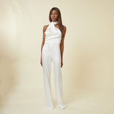 Elevate your style with our chic jumpsuit featuring an elegant draped scarf detail. This modern asymmetrical one-piece with an open back and slightly flared leg offers a sleek and polished look. Perfect for any dressy occasion whilst looking effortlessly sophisticated. Do not wash. Do not bleach. Low Iron. Dry clean only. Elegant Satin Jumpsuits And Rompers For Party, Elegant Fitted Jumpsuit For Wedding Guest, Chic Fitted Satin Jumpsuits And Rompers, Chic Satin Jumpsuits And Rompers For Evening, Chic Summer Jumpsuits And Rompers For Gala, Elegant Fitted Satin Jumpsuits And Rompers, Chic Formal Satin Jumpsuits And Rompers, Elegant Satin Pantsuit For Evening, Elegant Satin Jumpsuits And Rompers For Summer