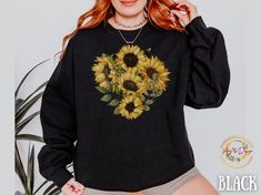 "This women's chicken sweatshirt offers a cozy and stylish fit that you'll love to wear. The whimsical graphic design featuring chickens and sunflowers captures the essence of farm life, making it an ideal gift for animal lovers who appreciate the beauty of farm animals. Embrace the spirit of fall with this fall crewneck sweatshirt that effortlessly transitions from the garden to autumn gatherings. Whether you're strolling through the wildflowers or enjoying Thanksgiving festivities, this sunflower-themed sweater adds a touch of rustic charm to your outfit. Unisex Heavy Blend™ Crewneck Sweatshirt- Chicken Sweatshirt,Sunflower Gifts Fall Leaves Sweatshirt, Thanksgiving Sweatshirt  Main Store: https://www.etsy.com/shop/May5thDesign?ref=seller-platform-mcnav For this design on a Comfort color Fall Crew Neck Top With Sunflower Print, Chicken Sweatshirt, Thanksgiving Festivities, Fall Crewneck Sweatshirt, Fall Crewneck, Flower Sweatshirt, Tee Designs, Sunflower Shirt, Comfort Colors Tshirt