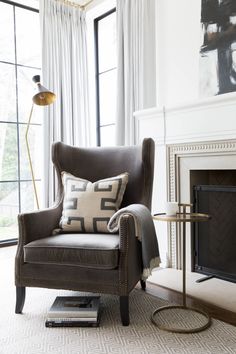 a living room with a chair and fireplace