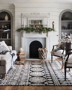 a living room filled with furniture and a fire place in the middle of a room