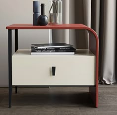 a red and white end table with books on it