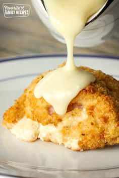 chicken cordon bleu sauce being drizzled on top of it