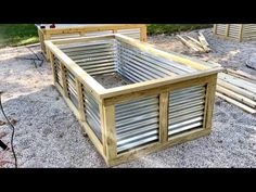 two wooden raised beds sitting on top of gravel