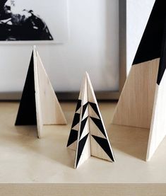 three pieces of wood sitting on top of a wooden table next to a framed photo