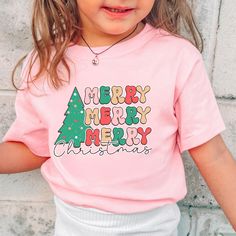 -Merry Christmas Toddler T-Shirt, Retro Merry Merry Christmas Tree Tee for Kids, Cute Holiday Shirt, Festive Christmas Toddler Outfit, Xmas Baby Gift Welcome to LittleLambsLounge! Fabric Information: -100% Cotton T-Shirts -Made to order -Handmade, unique designs -Ships the next business day -Our products come in 3 types: onesie® bodysuit, toddler, and youth size shirt. -The monthly sizes you choose will come as bodysuit® onesie®, available in both long sleeve and short sleeve options. We take pride in offering a delightful range of clothing for your little ones, crafted from super-soft fabrics that both you and your baby will adore. Our commitment is evident in every thread, as each piece is sustainably handmade-to-order, accompanied by a certificate of authenticity. FEATURES: We prioritiz Toddler Christmas Outfit, Christmas Toddler, Merry Christmas Tree, Tee Tree, Long Sleeve And Shorts, Toddler Christmas, Holiday Shirt, Holiday Shirts, Gender Neutral Baby