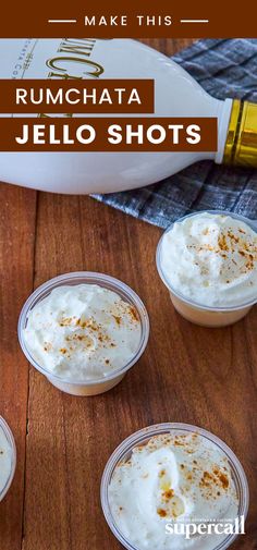 four small cups filled with whipped cream on top of a wooden table next to a bottle of rumchata