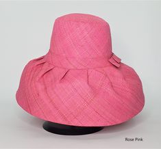 Raffia Curve Brim Hat in Rose Pink Colour    These amazing hats are dyed, loomed and sewn all by hand. Made in Madagascar. The hats are great sun protection having 2 layers on the brim and around the crown, 3 layers for crown top. Hats can be rolled up for packing in handbag or suitcase.    Measures 12cm brim.    Ethical, eco-friendly, sustainable.    About Raffia    Raffia is native to Madagascar and a sustainable resource to the country. Collectors go deep in the island to harvest the raffia f Pink Bohemian Sun Hat For Kentucky Derby, Bohemian Pink Sun Hat For Kentucky Derby, Pink Wide Brim Straw Sun Hat, Pink Handmade Short Brim Straw Hat, Handmade Pink Brimmed Straw Hat, Handmade Pink Straw Hat With Short Brim, Handmade Pink Straw Hat With Curved Brim, Pink Bucket Hat For Garden Party, Handmade Pink Wide Brim Sun Hat