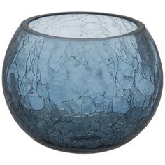 a blue glass vase sitting on top of a table