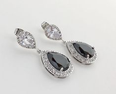 I've create this luxury black cubic zirconia bridal tear drop earrings in rhodium plated brass setting. Earrings feature a large teardrop with pear cut black cubic zirconia center surrounded by tiny round zirconia crystals. Teardrop dangles from a bright cubic zirconia ear stud. Total length of the earring is 3.5 cms. For matching necklace click: https://www.etsy.com/listing/520023845/black-cubic-zirconia-necklace-black?ref=shop_home_active_58 To browse my collection click : https://www.etsy.com Black Crystal Earrings For Wedding, Elegant Black Bridal Earrings For Formal Occasion, Black Jewelry With Sparkling Stones For Wedding, Black Sparkling Stones Jewelry For Wedding, Black Sparkling Stones Wedding Jewelry, Black Pear-shaped Jewelry For Weddings, Black Pear-shaped Wedding Jewelry, Black Wedding Jewelry, Gold Bridesmaid Jewelry