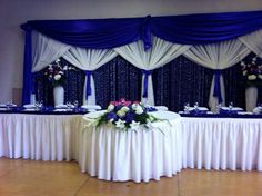 a banquet table set up with blue and white decor