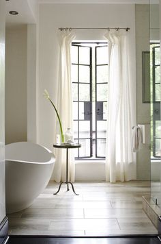 a white bath tub sitting next to a window