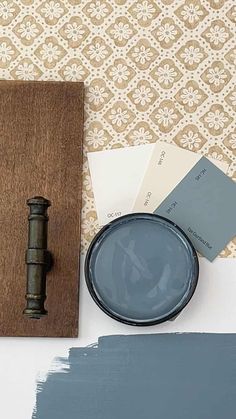 a table with some paint samples and a painting brush