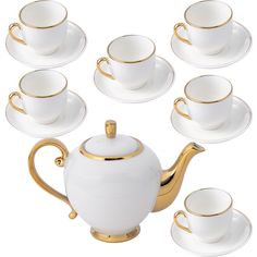 a white tea set with gold trimmings and saucers