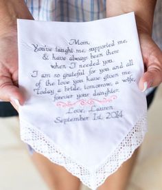 a person holding a handkerchief with a poem written on it in front of their hands