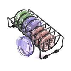 a black wire basket filled with different colored plates on top of each other next to a white background