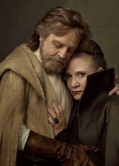 a man and woman are hugging each other in star wars costumes, one is wearing a cloak