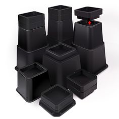 a group of black square and rectangle vases with red arrow pointing to them