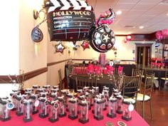 a table topped with lots of trophies and balloons