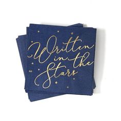 three blue napkins with gold lettering on them