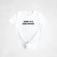 Handmade Damn I'm a Good Mother T-shirt. The perfect shirt for all Mom's! Makes the best Mother's Day Gift. H O W T O O R D E R Y O U R S H I R T : At checkout, please select the size you want, add to your cart, and then checkout through Etsy. If the size you want isn't in stock, I will message you right away and there will be a 2-3 day turn around time added to getting your shipment out. If you have a time deadline and want to check sizes on hand before you purchase, feel free to message me! Al Cotton T-shirt With Slogan For Gifting, Cotton Slogan T-shirt As Gift, Mother's Day Gift T-shirt, Relaxed Fit T-shirt With Letter Print For Gift, Relaxed Fit Letter Print T-shirt For Gift, Relaxed Fit Letter Print T-shirt As Gift, Relaxed Fit T-shirt With Letter Print As Gift, Cotton T-shirt With Letter Print For Gift, Slogan Tops For Mother's Day Gift