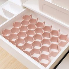 an open drawer with several compartments in it