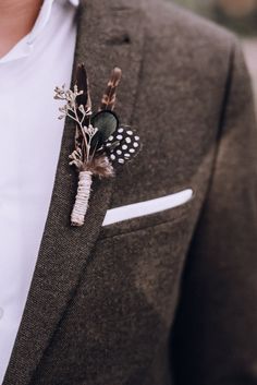 a man in a suit with a boutonniere on his lapel