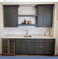 a kitchen with gray cabinets and white marble counter tops is featured in an article about remodeling