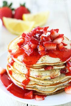 a stack of pancakes covered in strawberry syrup